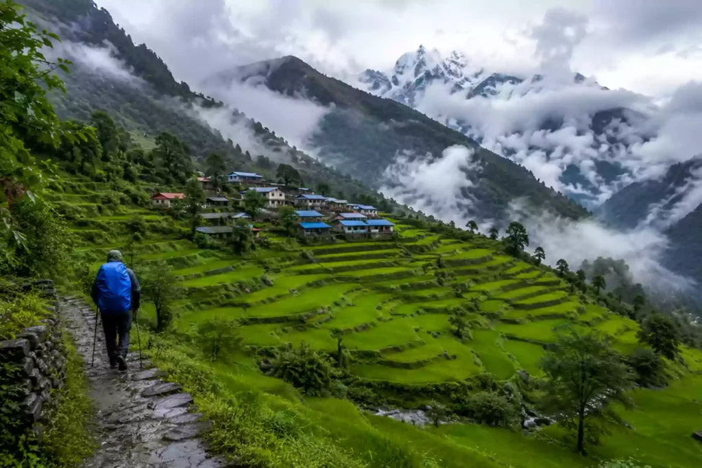 Nepal trekking monsoon — lush green terraced rice fields with mist-covered Himalayan hills in July, Annapurna region | Nepal Footprint Holiday