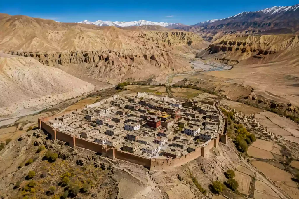 Aerial view of the historic Lo Manthang walled city surrounded by high desert canyon terrain during an Upper Mustang trek with Nepal Footprint Holiday.