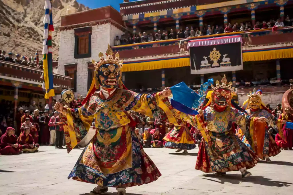 Tibetan Buddhist monks performing a traditional masked ritual dance during the Tiji Festival in the historic Lo Manthang courtyard with Nepal Footprint Holiday.