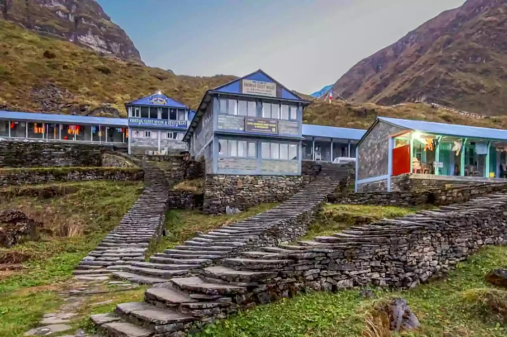 Teahouse along the Annapurna Base Camp trekking trail set against a dramatic mountain background