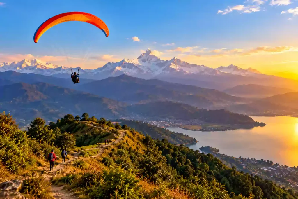 Paraglider flying over Pokhara valley and Phewa Lake with Annapurna mountain range in the background – Nepal Footprint Holiday