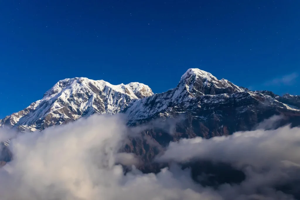 Annapurna South rising above clouds at Mardi Himal Base Camp in Nepal